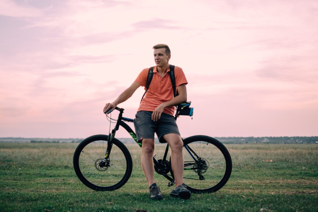 Man with bicycle. Exercise is an important factor in men's health.